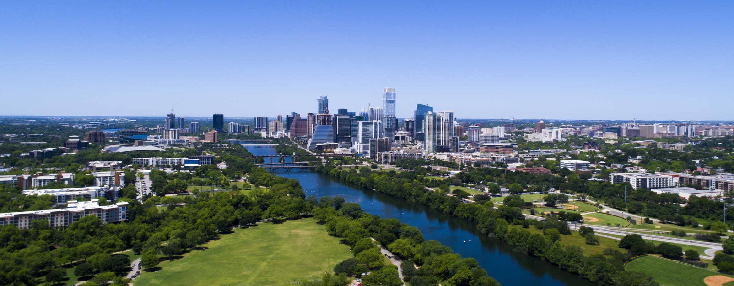 An aerial view of downtown Austin, Lady Bird Lake and Zilker Park.